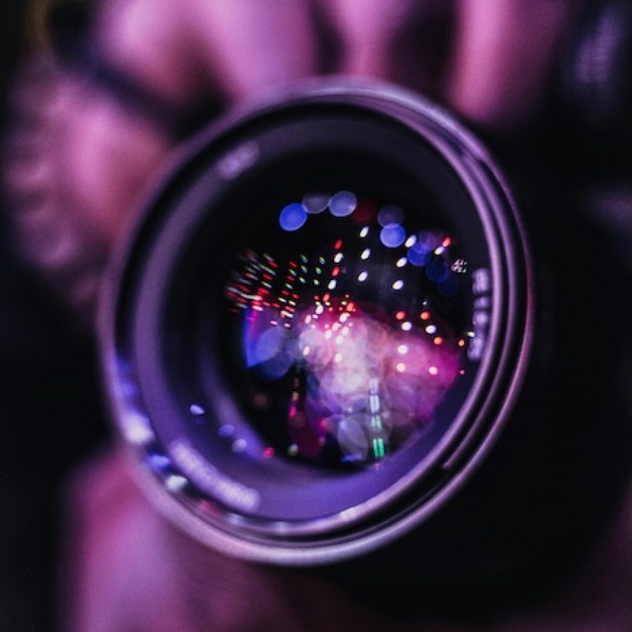 Linse eines Fotoapparates im violetter Event-Illuminierung